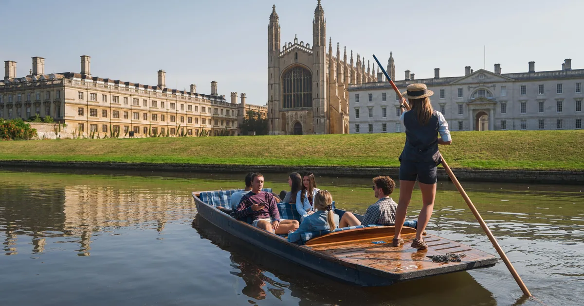 A chauffeured punt on the River Cam in front of King's College Chapel and the lawns of the Backs